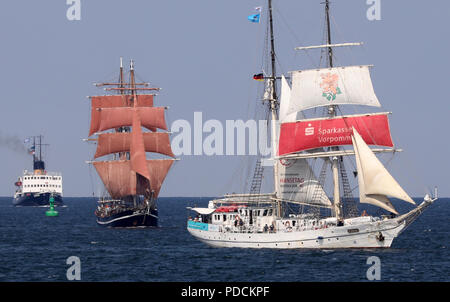 Warnemuende, Germany. 09th Aug, 2018. Traditional sailing ships and museum ships are on their way on the Baltic Sea for a first trip at the Hanse Sail, among them the steam ice breaker 'Stettin' (l) and the sailing training ship 'Greif' (r). The maritime spectacle is officially opened in the afternoon. (to '28th Hanse Sail will be opened - Largest sailors of the world' from 09.08.2018) Credit: Bernd Wüstneck/dpa/Alamy Live News Stock Photo