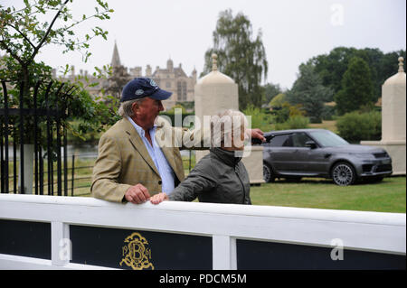 Stamford, Lincolnshire, UK. 9th August, 2018. 9th August 2018. Captain Mark Phillips and Elizabeth Inman pose in front of Burghley House during the 2018 Land Rover Burghley Horse Trials Media Preview Day, Stamford, United Kingdom. Jonathan Clarke/Alamy Live News Stock Photo