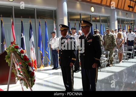 Lt. Gen. Michael X. Garrett (left), commanding general U.S. Army Central and Col. Joey T. Byrd (right), USARCENT chaplain  stand with the fellow Soldiers, civilians, community leaders and family members for a moment of silence at the USARCENT wreath laying ceremony Aug. 3 at Patton Hall to honor service members who died while assigned to USARCENT/Third Army over the past 100 years. (U.S. Army photo by Staff Sgt. Christal Crawford) Stock Photo