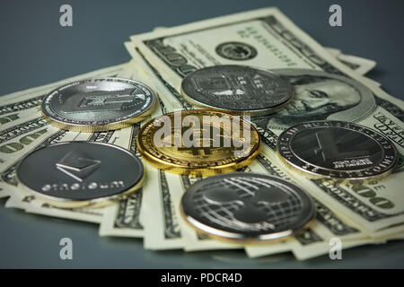 Coins of different crypto-currencies with dollars. Stock Photo