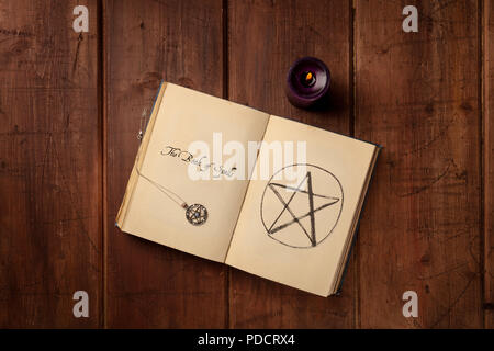 An overhead photo of an open witch's grimoire, book of spells, with pentacles and copy space Stock Photo
