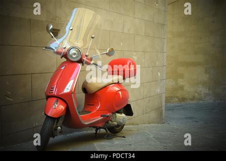 A Red Scooter Parked on an Italian Street Stock Photo