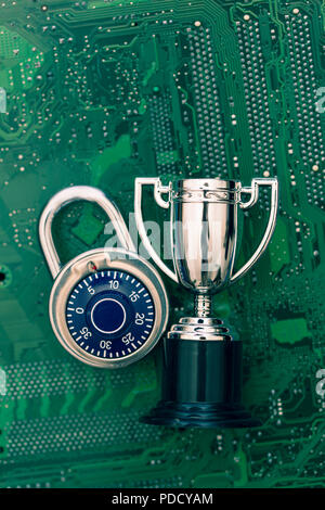 Data security expert. Padlock and trophy on a computer electronic circuit board. Stock Photo