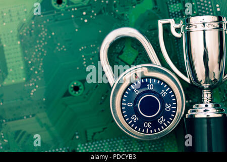 Data security expert. Padlock and trophy on a computer electronic circuit board. Stock Photo
