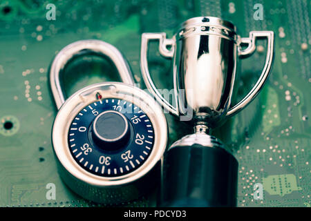 Data security expert. Padlock and trophy on a computer electronic circuit board. Stock Photo