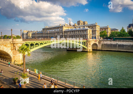 Parc Rives de Seine is a favourite place for tourists and locals to walk by the Seine River late in the afternoon in summer. Stock Photo