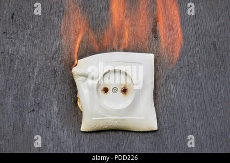 Faulty electrical wiring has caused ignition of electric socket, household fire in home power supply network. Stock Photo