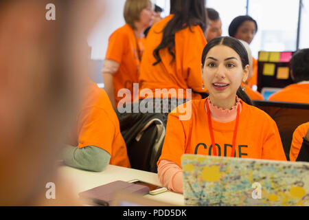 Hackers at laptop coding for charity at hackathon Stock Photo