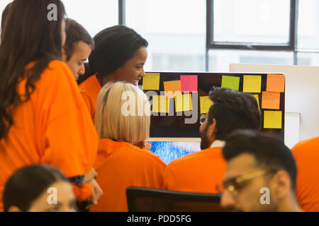 Hackers coding for charity at hackathon Stock Photo