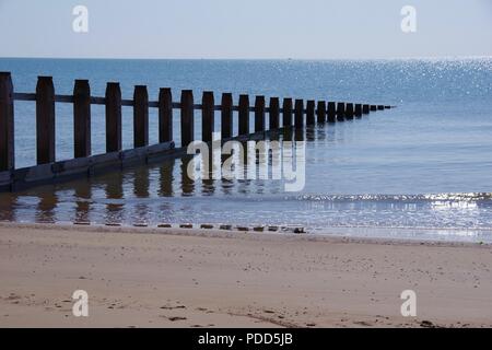 Wooden Beach Groyne at Dawlish Warren on a Calm Sunny Summer Day. Devon, UK. August, 2018. Stock Photo