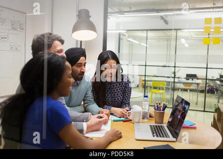 Creative business people video conferencing at laptop in conference room Stock Photo