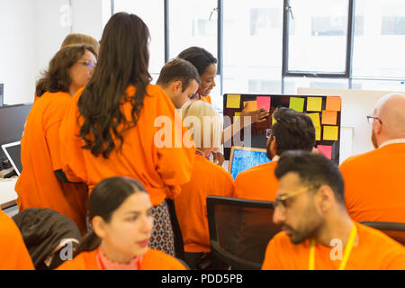 Hackers coding for charity at hackathon Stock Photo