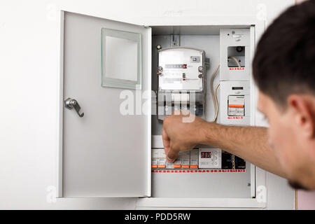 Electrical terminal box. man turn on or off Stock Photo
