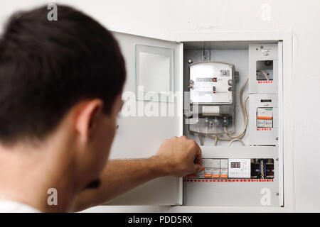 Electrical terminal box. man turn on or off Stock Photo