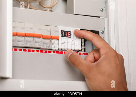 Electrical terminal box. man turn on or off Stock Photo