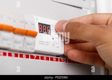 Electrical terminal box. man turn on or off Stock Photo