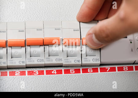 Electrical terminal box. man turn on or off Stock Photo