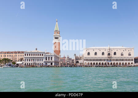 Doges Palace, St Marks Campanile and Marciana Library from the lagoon, Venice, Veneto, Italy with the Clock Tower and crowds of tourists  in summer Stock Photo