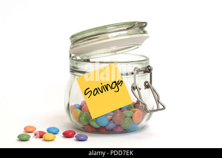 Colourful sugar candy sweets in a clip top glass jar with yellow post it note on outside Stock Photo