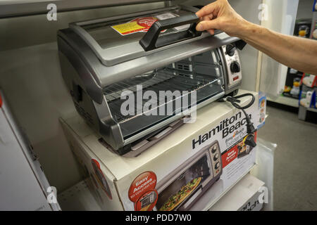 A shopper chooses a Hamilton Beach brand toaster oven in a home goods store in New York on Wednesday, August 1, 2018. Hamilton Beach is scheduled to report quarterly earnings on August 2 prior to the bell.  (© Richard B. Levine) Stock Photo