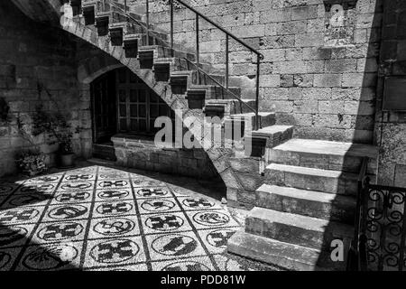 A black and white picture of a court yard of a medieval building in the old town of Rhodes, Greece Stock Photo