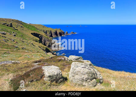 Distant Longships Lighthouse off Land's End from Maen Cliff Castle on the South West Coast Path, Sennen, Cornwall, England, UK. Stock Photo