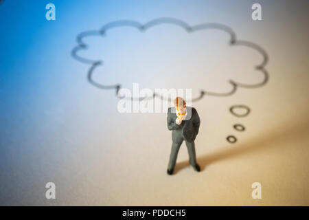 Business concept of decision. Businessman stand and thinking with doodle word cloud. Stock Photo
