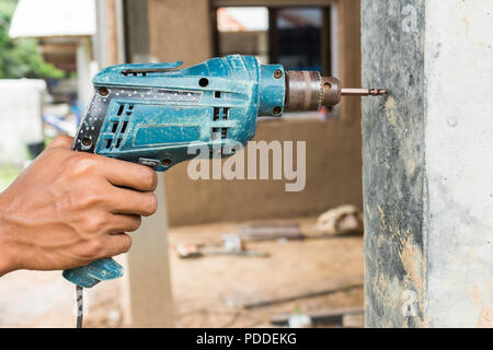 Drill machine drilling a cement Stock Photo