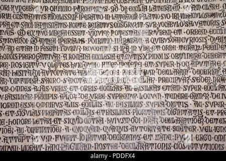 Ancient writings in Latin language of religious texts, very common in religious and historical buildings of many Italian cities. Stock Photo