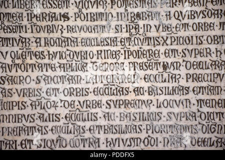 Ancient writings in Latin language of religious texts, very common in religious and historical buildings of many Italian cities. Stock Photo