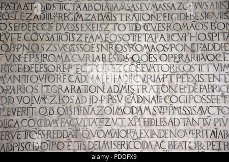 Ancient writings in Latin language of religious texts, very common in religious and historical buildings of many Italian cities. Stock Photo