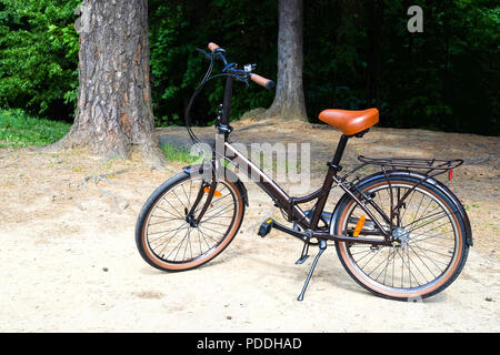 A pleasure folding women's bike with a trunk. Parking stop Stock Photo ...
