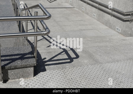 The entrance is decorated with granite and marble tiles with metal chrome railing Stock Photo