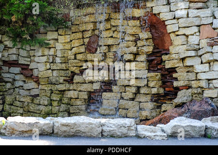 Waterfall in landscape design decorated with natural natural stone. Stock Photo