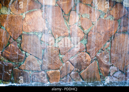 Waterfall in landscape design decorated with natural natural stone. Stock Photo