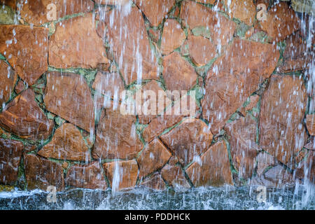 Waterfall in landscape design decorated with natural natural stone. Stock Photo