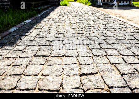 The stone pavement of the blocks. Granite paving. Stock Photo