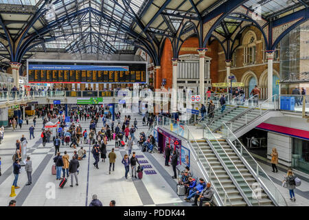 Liverpool Street, London, UK - April 6, 2018: Busy scene inside Liverpool Street mainline station with lots of passengers.  Taken from a vantage point Stock Photo