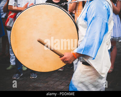 Drummer performance, Taiko Drums Japanese folklore. Japanese artists perform at Bon Festival in blue kimonos with big drums. Stock Photo