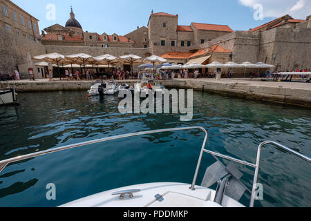 Boat arriving at the harbor in Dubrovnik old town, Croatia, Europe Stock Photo