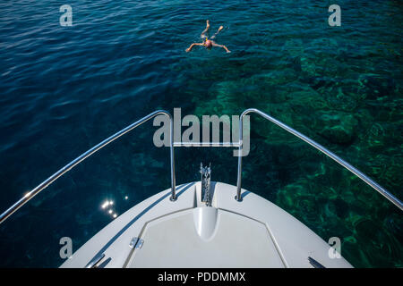 Man snorkeling near a yacht Stock Photo