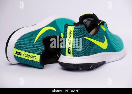 Pair of green Nike Flex Experience RN 5 running shoes cut out isolated on white background Stock Photo