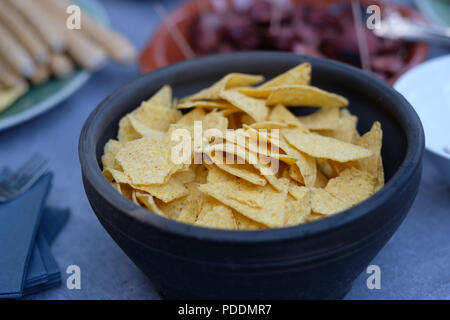 Close up of a bowl of nachos (mexican chips) on a table Stock Photo