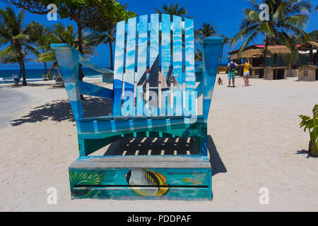 LABADEE, HAITI - MAY 01, 2018: The sitting area with wooden bench at sunny day on beach in Haiti Stock Photo