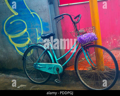 bicycle parked in front of a orange wall with a thumbs up sign. Stock Photo