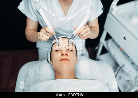 Beautician makes face rejuvenation procedure Stock Photo