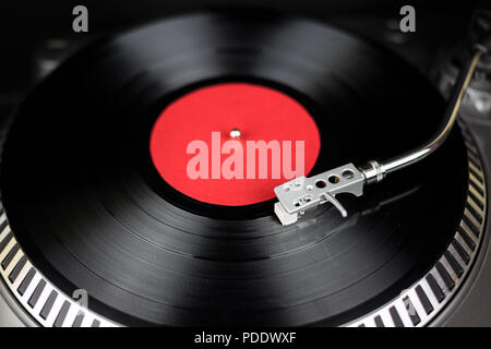 Professional turntable close-up. Analog stage audio equipment for concert in nightclub. Play mix music tracks on vinyl records. Turntables needle cartridge scratches vinyl disc. DJ setup for festival Stock Photo