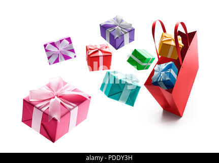 Gift boxes pop out from red shopping bag isolated on white background Stock Photo