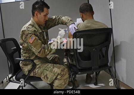 Soldiers across 10th Mountain Division made their way through a Soldier Readiness Processing site in Clark Hall to complete medical screenings during Mountain Strike, an emergency deployment readiness exercise, May 12, at Fort Drum, New York. The U.S. Army Forces Command directed exercise aims to use the upcoming 2BCT rotation to the Joint Readiness Training Center, at Fort Polk, Louisiana, as an opportunity to test the combined expeditionary capabilities of 10th MTN DIV and Fort Drum as an installation. Stock Photo