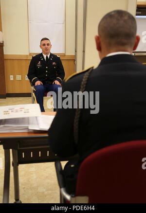 U.S. Army 2nd Lt. Nicholas Paneral, native to Chicago, Illinois assigned to the 65th Medical Brigade, answers a question at the Officer Board during the Eighth Army 2018 Best Warrior Competition, held at Camp Casey, Republic of Korea, May 16, 2018.  The Eighth Army Best warrior Competition is being held to recognize and select the most qualified junior enlisted and non-commissioned officer to represent Eighth Army at the U.S. Army Pacific Best Warrior Competition at Schofield Barracks, HI. The competition will also recognize the top performing officer, warrant officer and Korean Augmentation t Stock Photo
